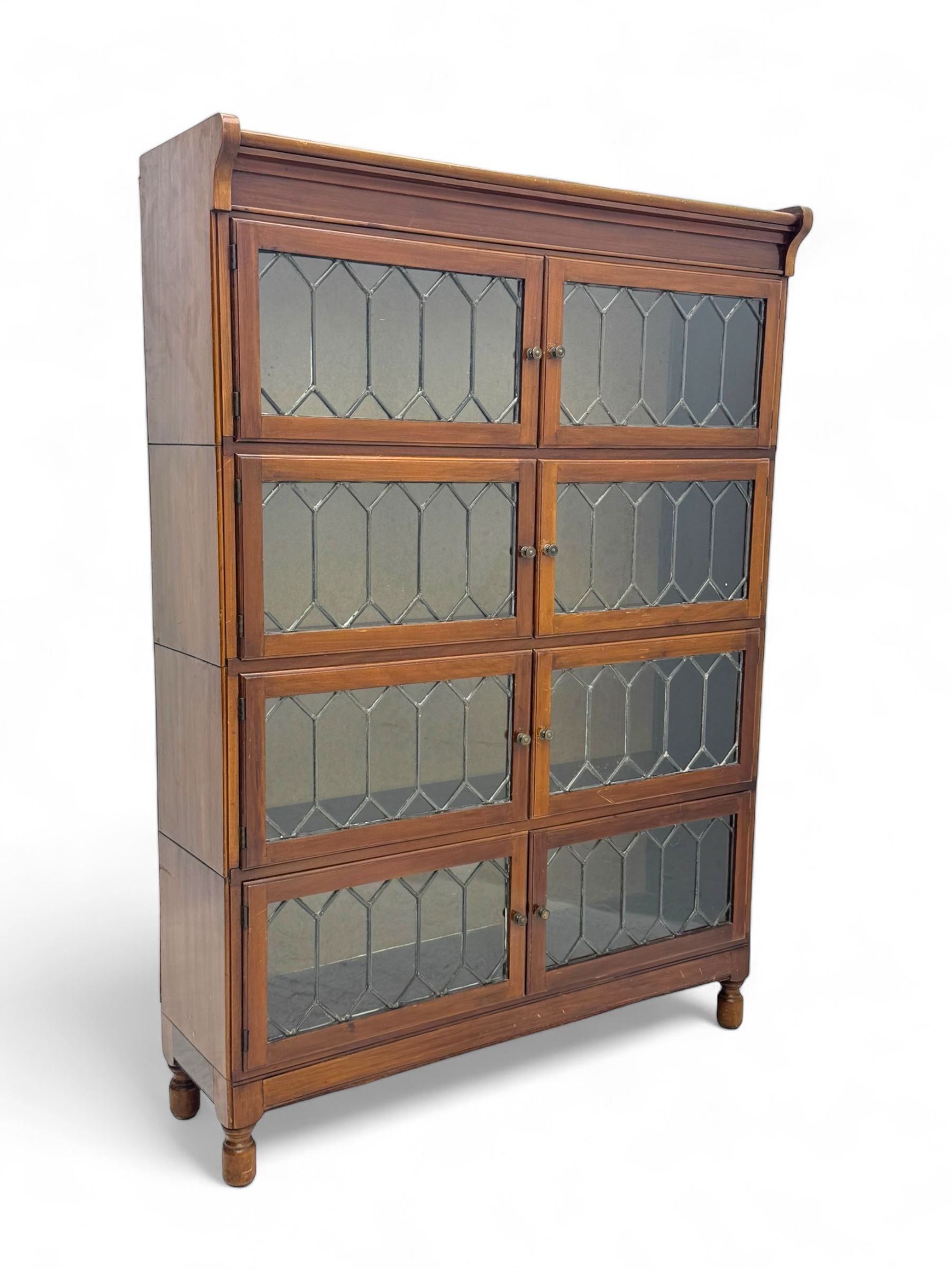 Early 20th century Globe Wernicke design stacking walnut bookcase, fitted with four sections each with two leaded glass doors, raised on turned feet