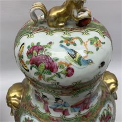 Pair of 19th century Chinese Famille Rose vases and covers, each of baluster form with twin gilt lion mask ring handles to shoulders, the flattened domed covers with gilt temple lion finials, each decorated with alternating reserves of bijin and attendants, and birds and butterflies amongst blossoming peonies, against a gilt ground profusely decorated with stylised scrolls, H32.5cm