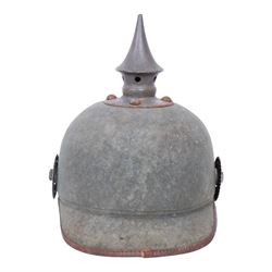 WWI Prussian 22nd regiment Ersatz Felt Pickelhaube, the grey felt skull with steel spike finial, 22 helmet plate and leather chin strap, one side with a black cockade, the other black and red,  the inner back brim stencilled BA 1X Wm Kleddinghaus & C, Elberfeld, 1916, H24cm
