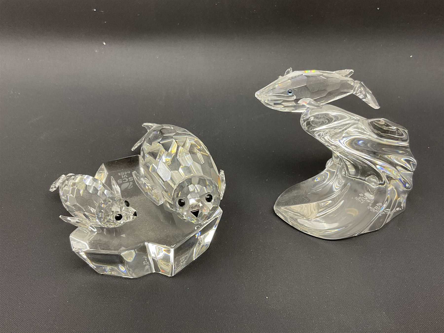 Nineteen Swarovski Crystal sea creatures, to include dolphins, seals, puffer fish, octopus, crabs, together with a quantity Swarovski Crystal shells 