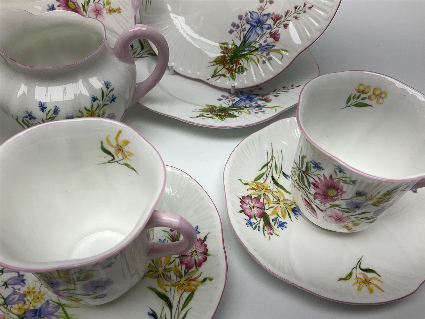 Shelley Wild Flowers pattern part tea service, comprising four cups and saucers, four dessert plates, cake plate, milk jug and open sucrier