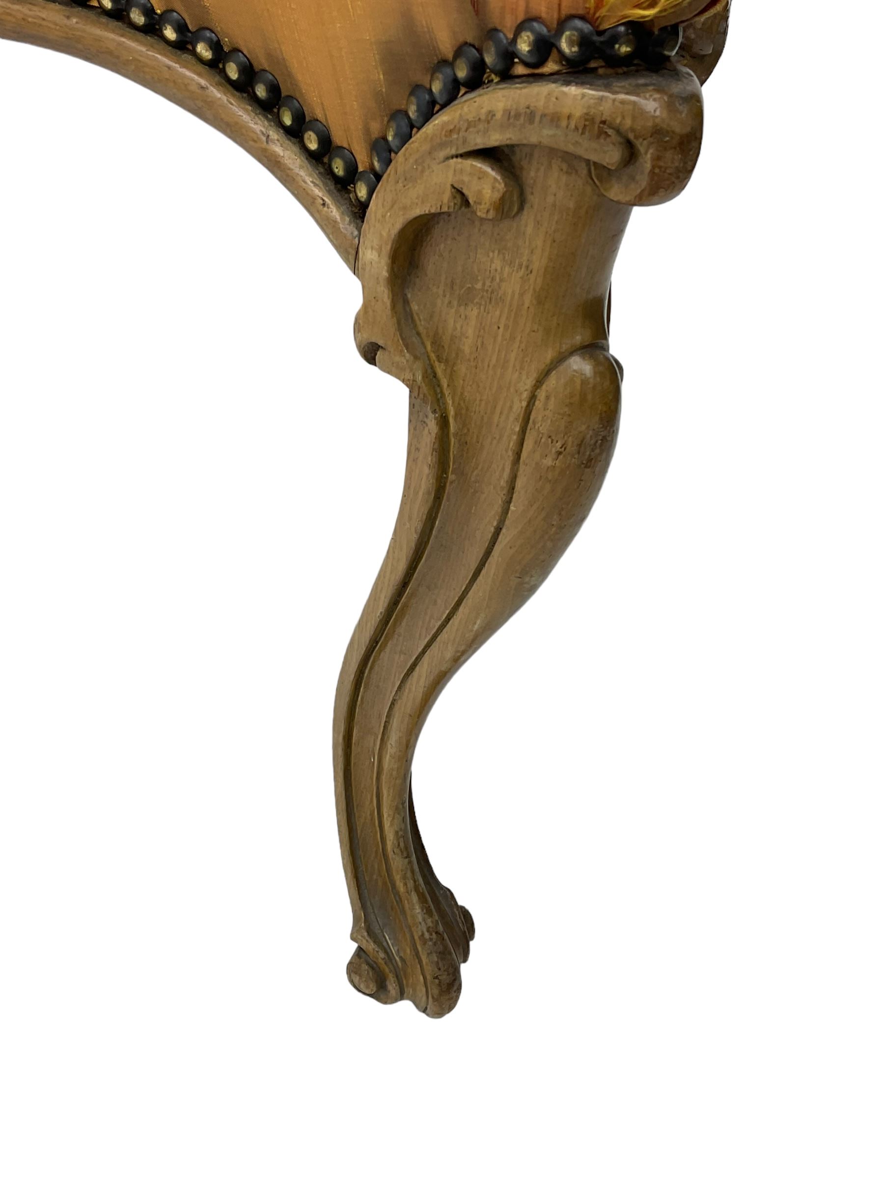 Pair of Victorian walnut side chairs, shaped cresting rail carved with acanthus leaves, overstuffed upholstered seats with stud band, on cabriole supports with scroll carved terminals