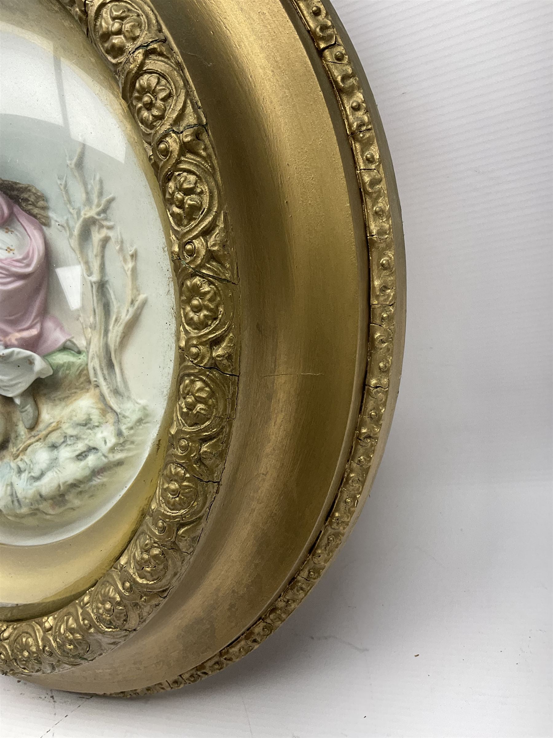 Set of four early 20th century Continental bisque plaques, each of circular form, modelled in high relief as the Four Seasons personified, within gilded circular frames under convex glass, overall D44.5cm