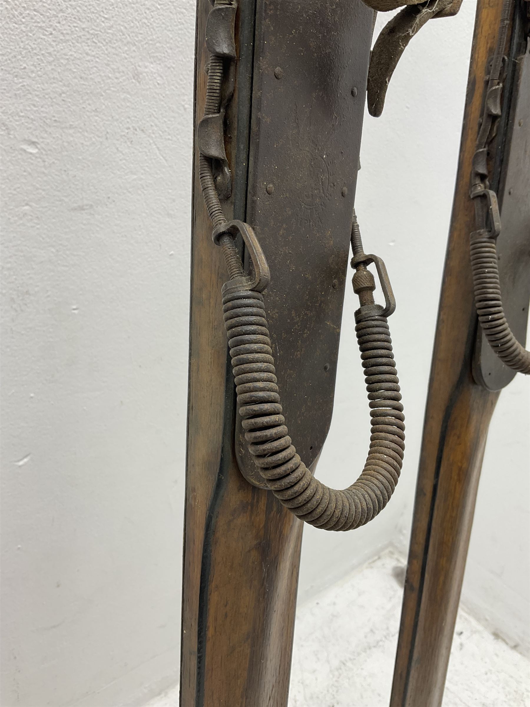 Pair of 1930s wooden skis, with painted metal runners beneath stamped Attenhofer, with retailers label for Ernst Gertsch Central Sports, L206cm