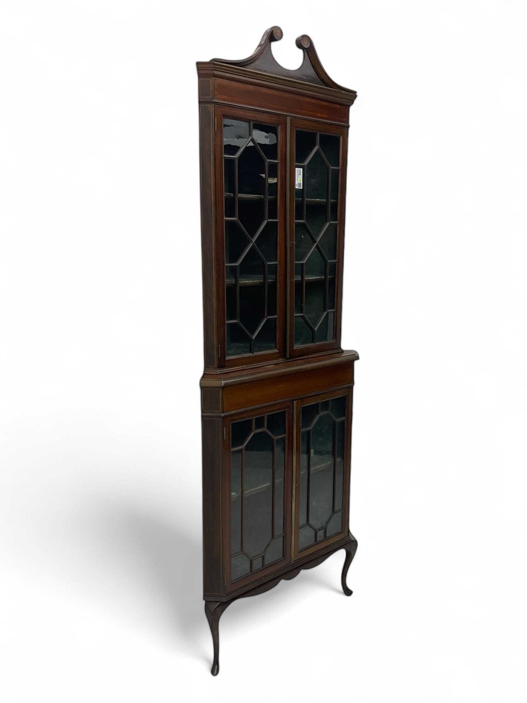 Edwardian mahogany corner display cabinet, scrolled swan neck pediment over astragal glazed doors, fabric lined interior, on cabriole feet 