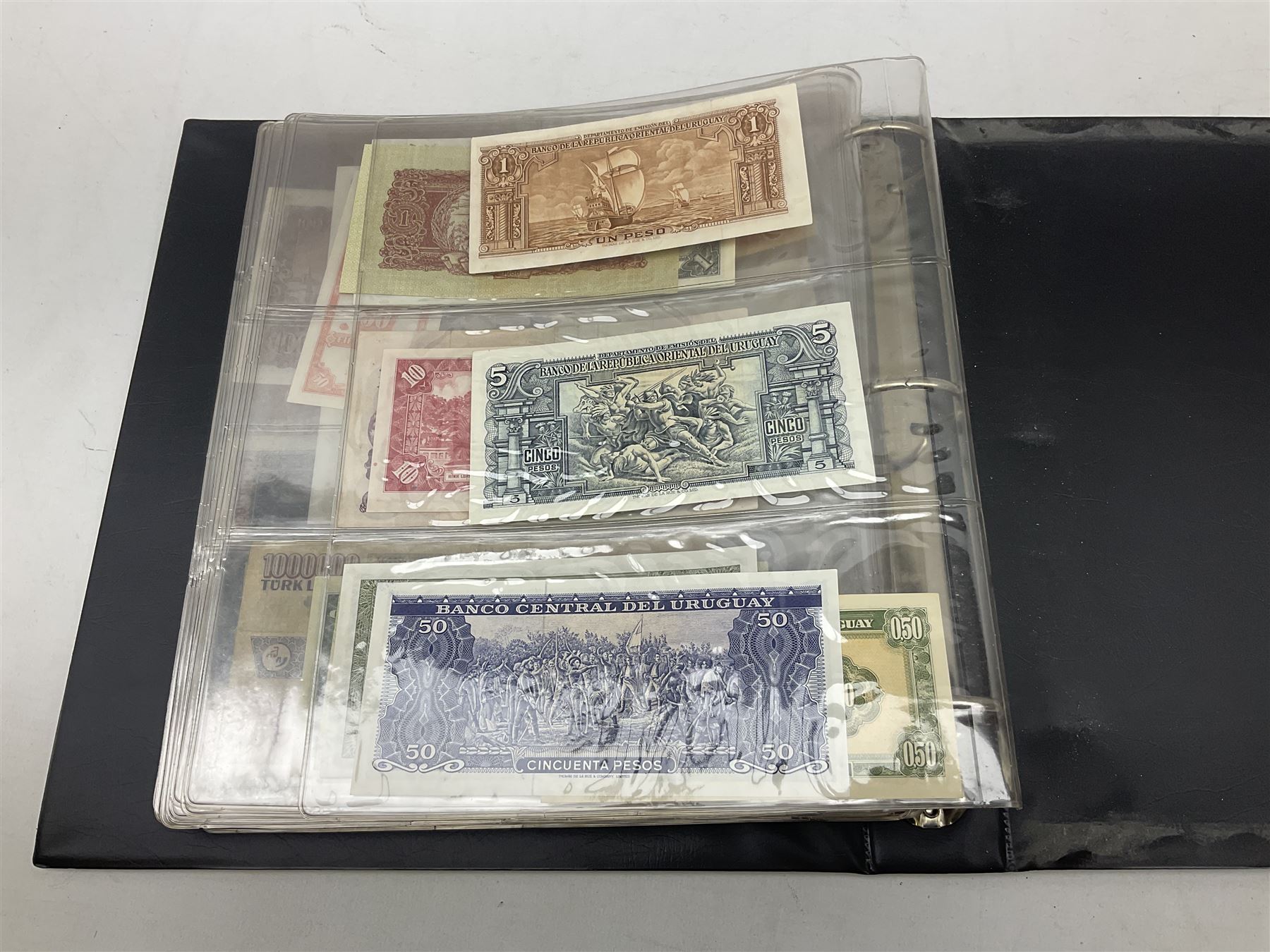 World banknotes, including Queen Elizabeth II The States of Jersey one pound 'DB202703', five pounds 'BB527762' and ten pounds 'AB651481', reserve bank of New Zealand two dollars '1L3 741894', King George V Straits Settlements one dollar 1st January 1935 'F/83 28924', various Bank of England notes etc, housed in two ring binder albums