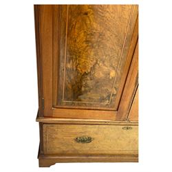 Late Victorian walnut triple combination wardrobe, projecting moulded and dentil cornice, central shaped bevelled mirror glazed door, cartouche and curled leaf carved panels over figured walnut veneered panels, fitted with drawer to base, on bracket feet