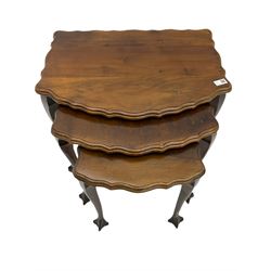 Late Victorian walnut bedside cabinet, nest of three walnut tables with scalloped tops and a three tier folding cake stand 