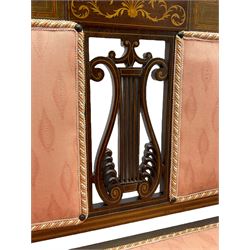 Edwardian inlaid mahogany two-seat settee or hall bench, the cresting rail inlaid with satinwood banding and boxwood stringing, central panel inlaid with scrolled leafy branches over pierced and carved lyre back, upholstered in peach fabric with repeating pattern, scrolled down sweeping arms, on square tapering supports with spade feet 