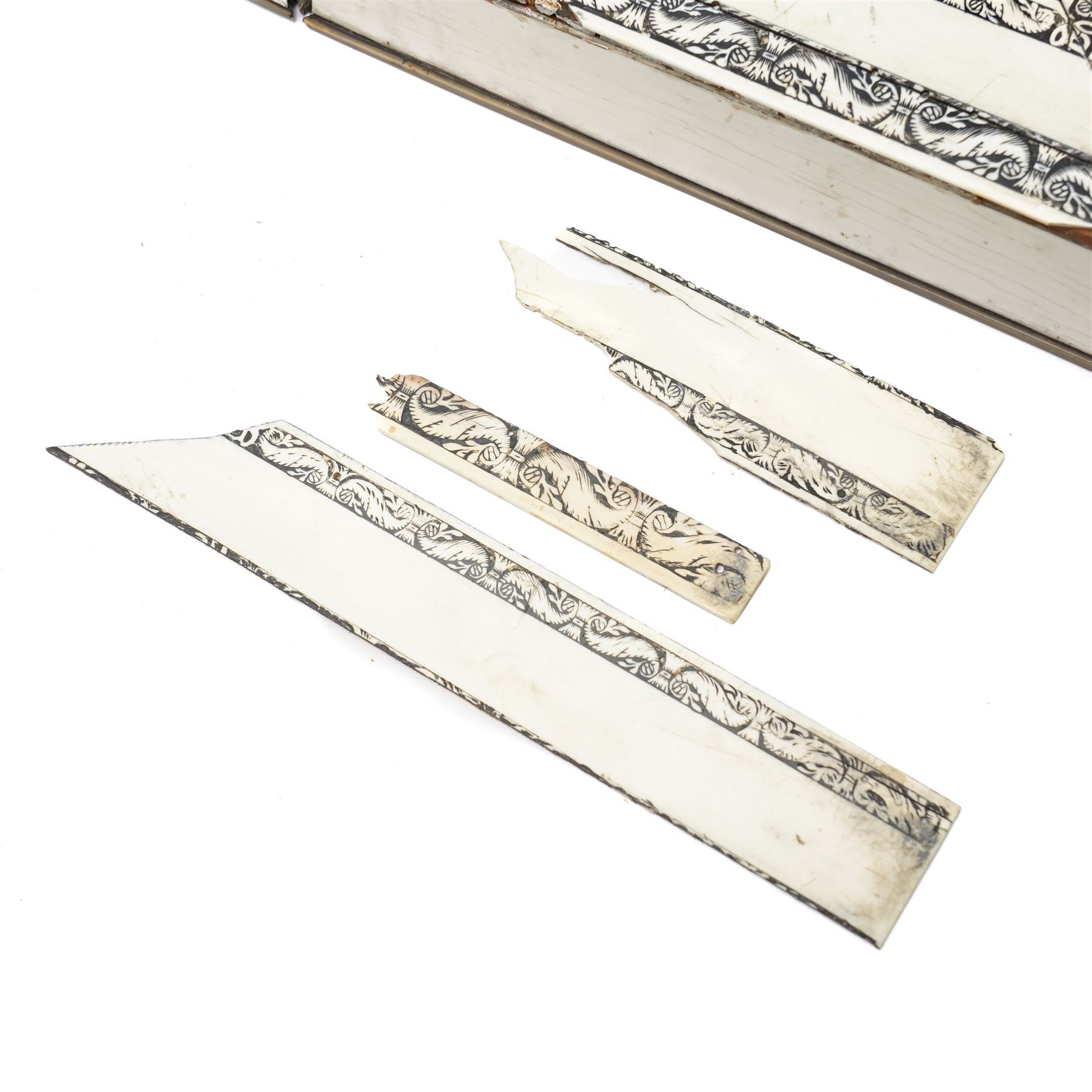 Mid-19th-century Anglo Indian Vizagapatam ivory, sandlewood, and horn veneered backgammon/chess board, circa 1860, rectangular games box the borders engraved with a stylized scrolling leaf decoration and spine engraved History of Persia the interior inlaid for backgammon, with three internal sandalwood boxes with covers, containing 16 ivory pieces and 16 horn pieces, comprising, kings and queens with pierced crowns on baluster carved shafts; bishops with carved mitres; knights represented by horses’ heads; and rooks as towers with imbricated decoration.

This item has been registered for sale under section 10 of the APHA Ivory Act, submission reference G68PNYA5 

