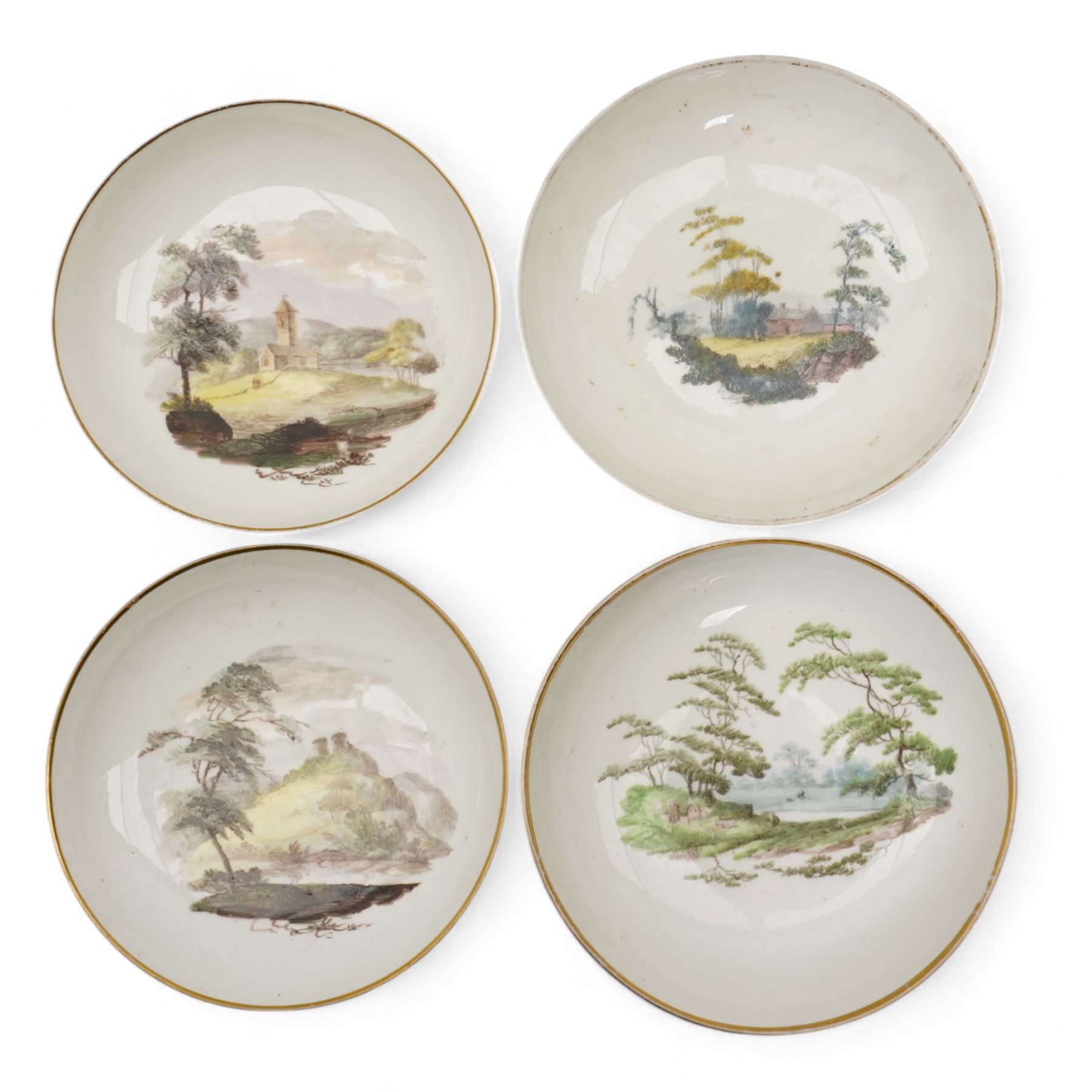 Set of four Pinxton porcelain bute shaped teacups and saucers, circa 1796-1813, pattern no. 218, painted in polychrome with landscape panels within gilt rims, possibly by John Cutts, three pieces numbered 218 beneath, saucer D14cm, teacup H6cm (8)