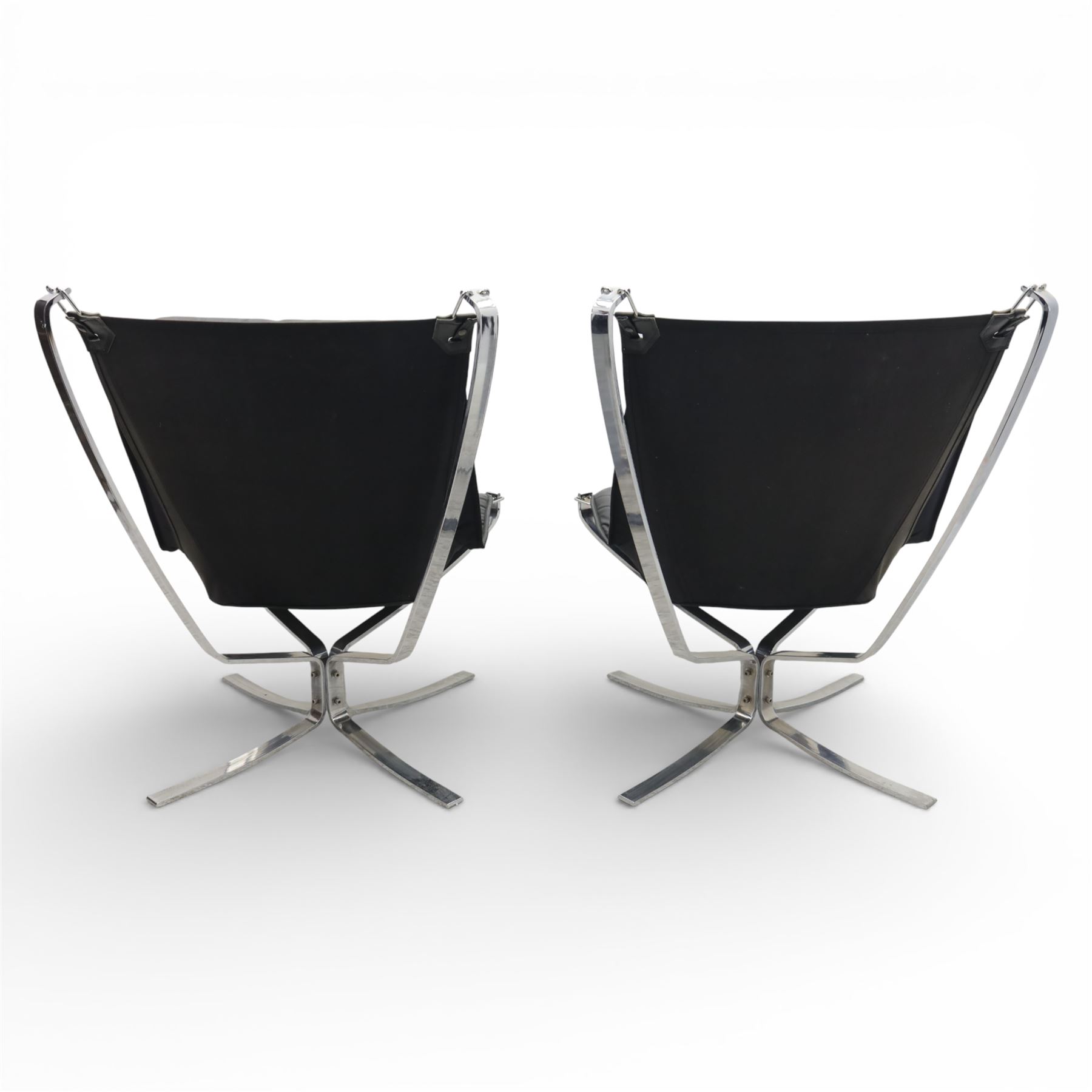 Pair of modernist black leather and chrome armchairs, in the manner of  Vatne Møbler, black leather sling seats suspended within chromed steel brackets, supported by polished chrome cross bases