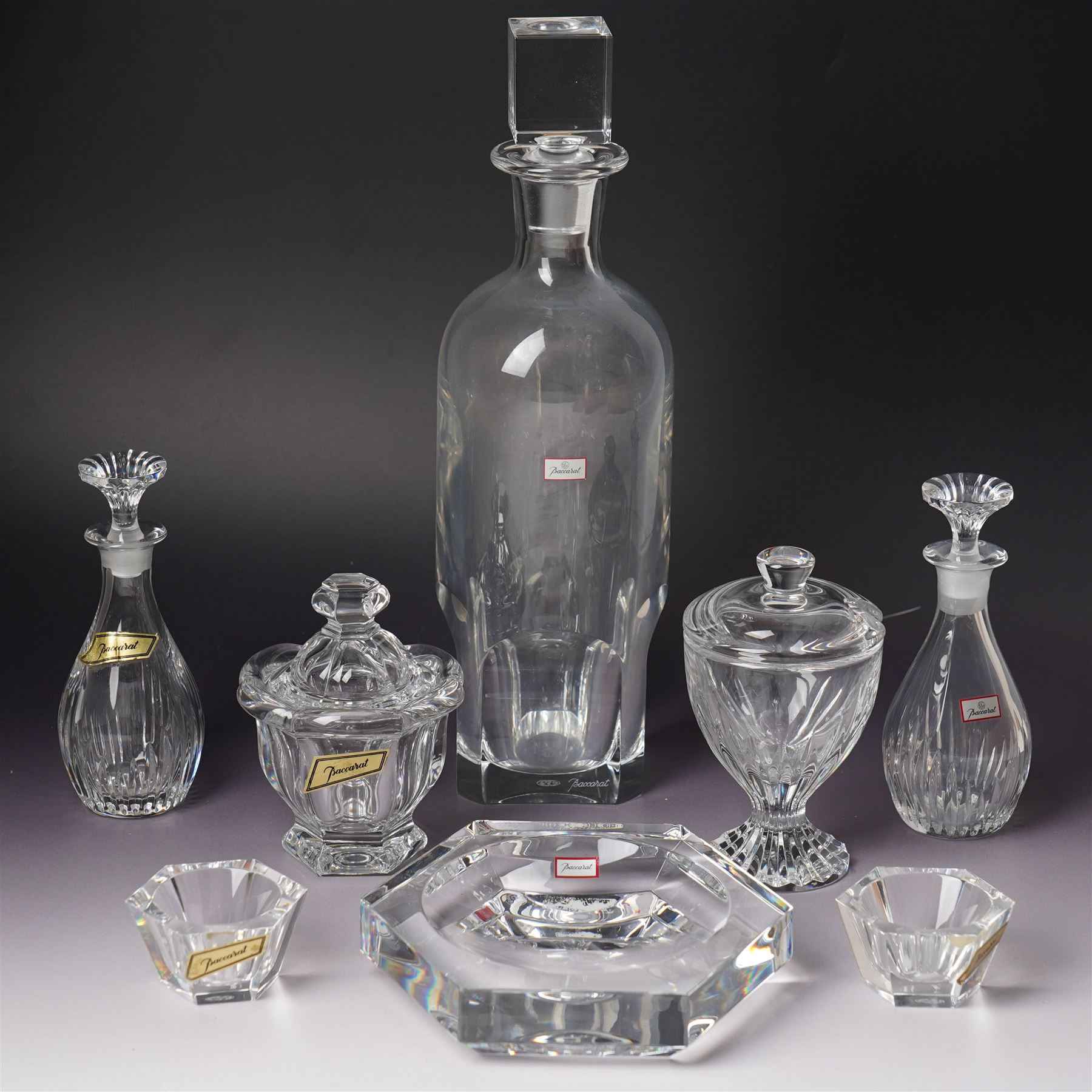 Collection of Baccarat Crystal, comprising a 'Pluton' decanter and two smaller examples, two covered condiment jars, pair of salt cellars, and an ashtray, variously boxed