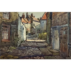 J K Burtonshaw (British 20th century): Sunny Place towards tommy Baxter Street Robin Hoods Bay, watercolour signed and dated 1970, 37cm x 55cm