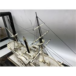 19th century prisoner of war ivory model of a paddle steamer, with planked and pinned deck and hull above the waterline, and copper cladding beneath, two rigged masts, twin paddles, and two anchors, upon an ivory inlaid rectangular plinth base, contained within an ebonised display case with five glazed panes, overall H40cm L70.5cm W28.5cm