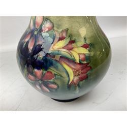 Moorcroft vase of baluster form decorated in the Spring Flowers pattern upon a merging green and blue ground, with impressed and painted marks beneath, H22.5cm