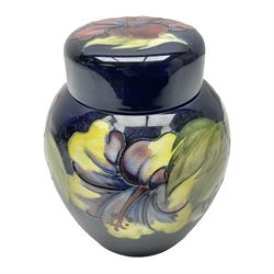 Moorcroft ginger jar, decorated in the Hibiscus pattern upon a cobalt blue ground,  with impressed Moorcroft, Made in England marks beneath and paper label detailed Potters to the late Queen Mary, H15cm