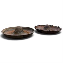 Two early 20th century cast iron ‘Mexican hat’ pig trough planters, each of circular dished form with central domed boss, one fitted with fixing studs for radial feeding divisions
