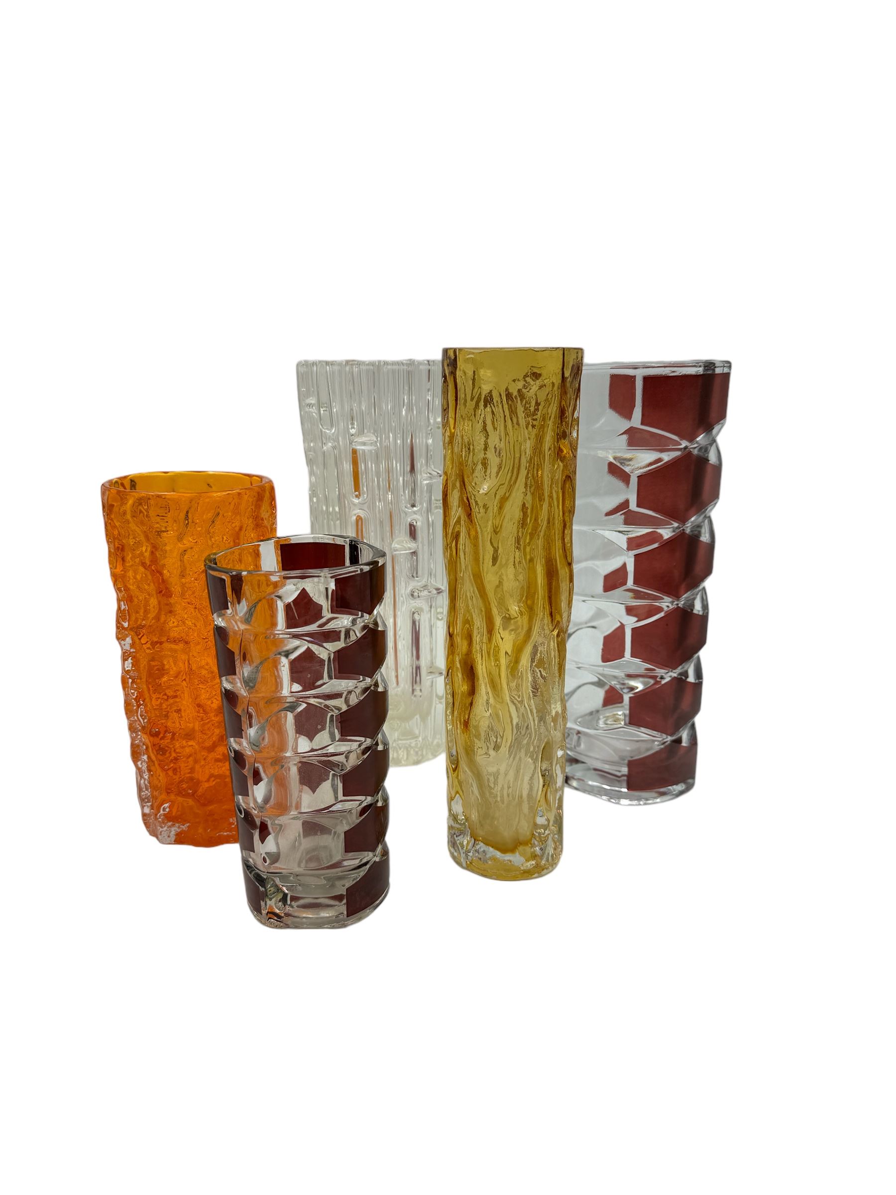 Sklo Union clear glass labrinth vase by Frantisek Vizner, together with two Luminarc geometric cranberry glass vases,Whitefriars style vase in the tangerine colourway, and one other 