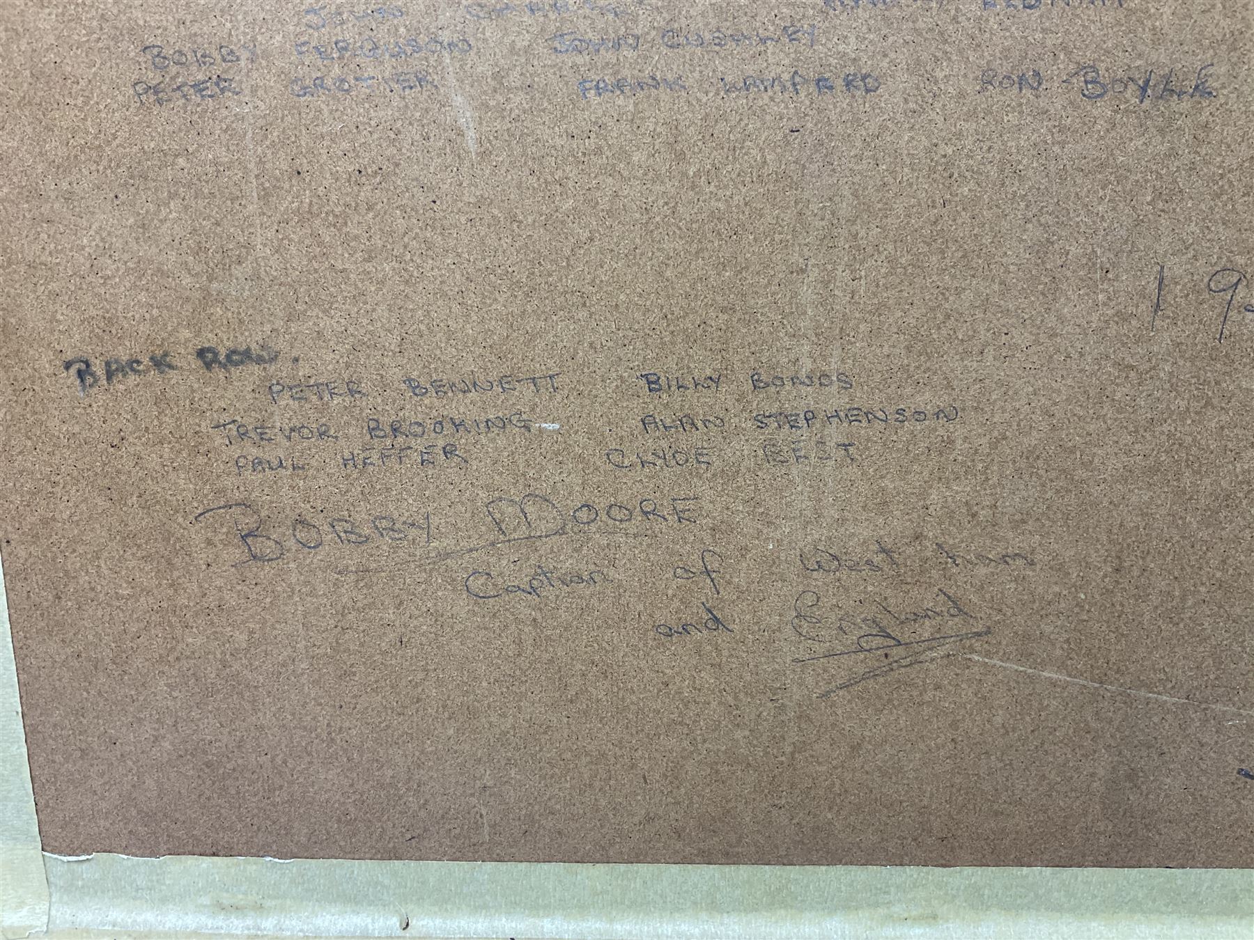 1970-1 photograph of West Ham United FC squad members, including Bobby Moore, Geoff Hurst, Harry Redknapp, Trevor Brooking, Jimmy Greaves, Billy Bonds etc, most players with signatures, 30 x 45cm, framed and glazed