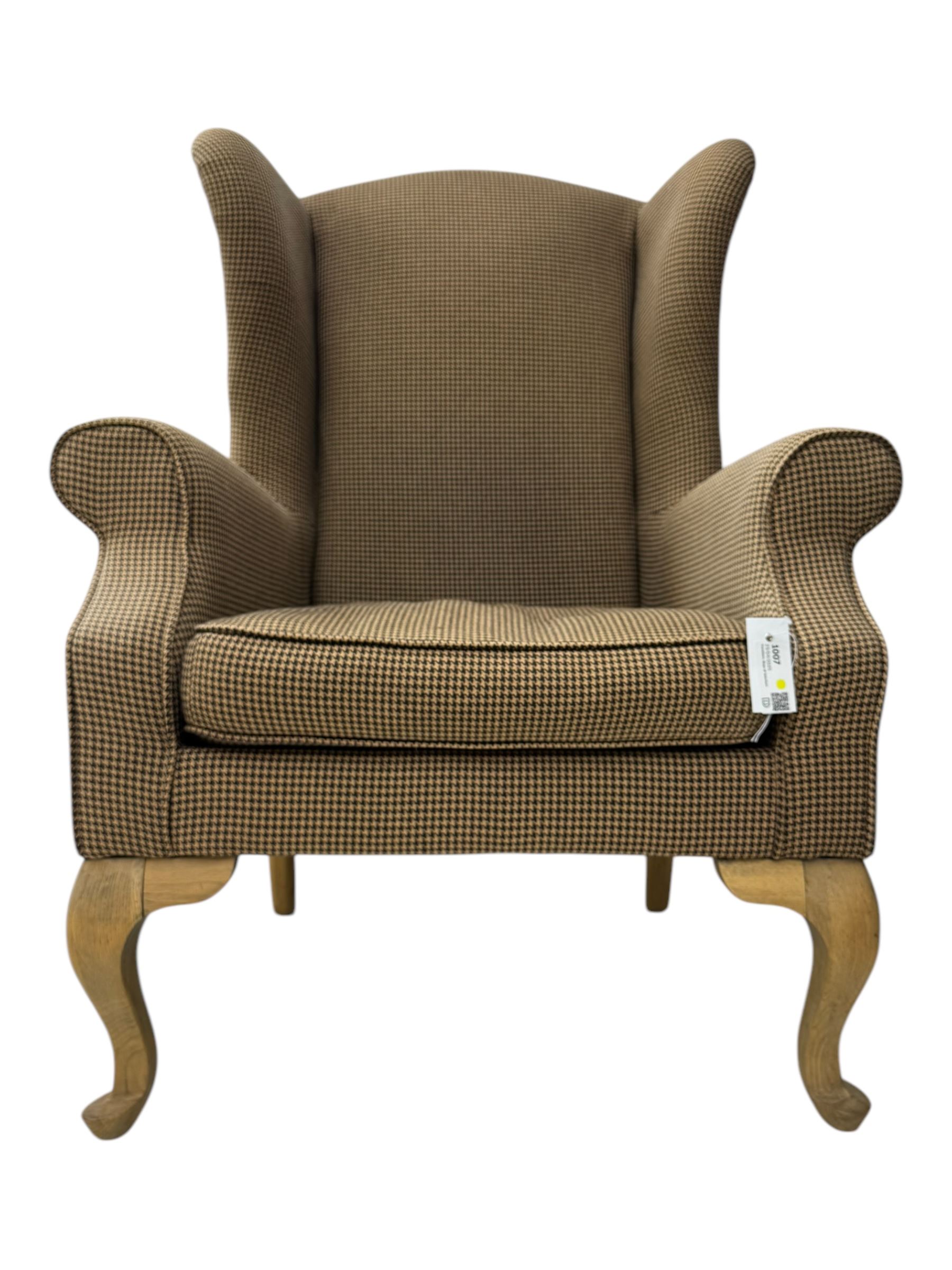 Hardwood-framed wingback armchair, upholstered in dog tooth pattern fabric, on cabriole supports 