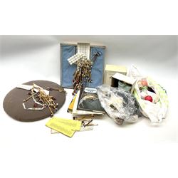 A quantity of lace making equipment, to include pillows, wooden bobbins, boxed bobbin winder, books, etc. 