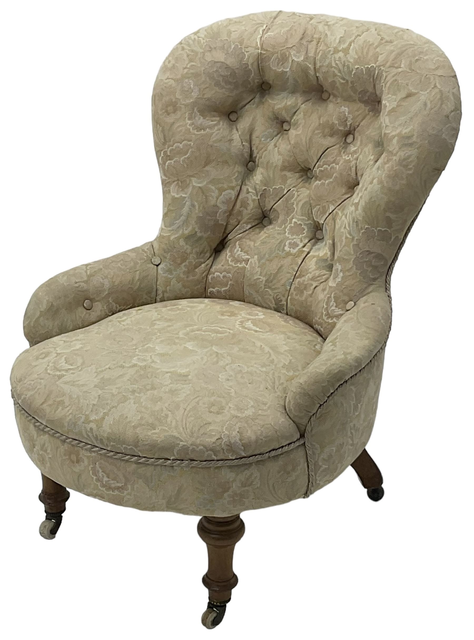 Victorian walnut framed nursing chair, upholstered in buttoned floral pattern fabric, on turned front feet 