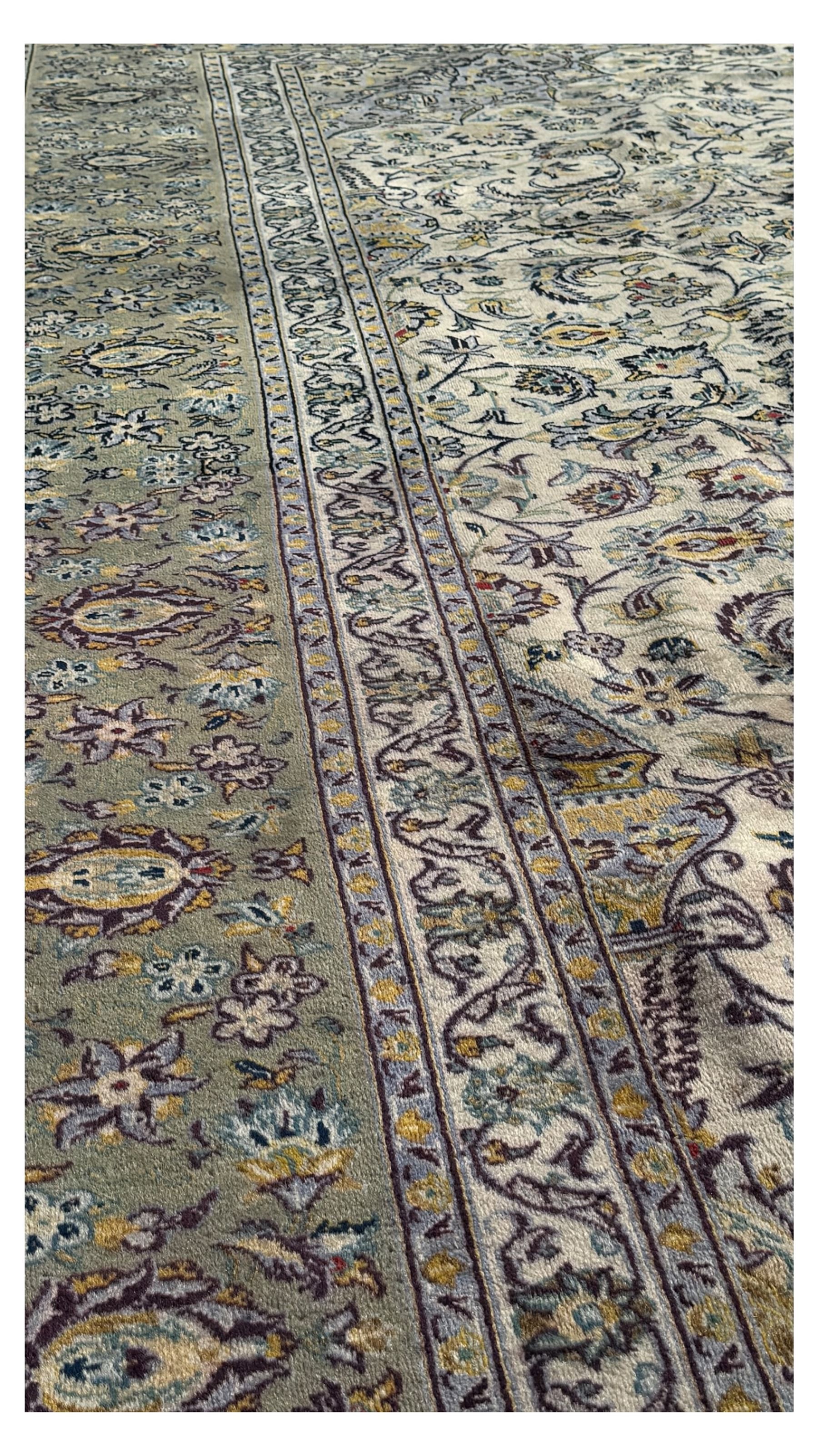 Kashan Persian rug, hand knotted, ivory ground rug, the rosette medallion decorated with projecting palmettes, on a field of swirling leafy branches and decorated with further palmettes, the scrolling border with repeating stylised plant motifs, within floral pattern guard stripes