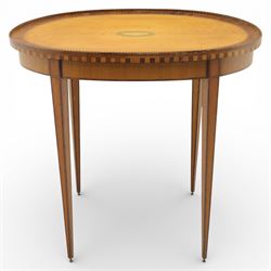 Early 19th century Sheraton revival satinwood oval table, shell motif to the centre bordered by walnut veneer, with inlaid banding, supported on square tapering legs terminating in brass feet