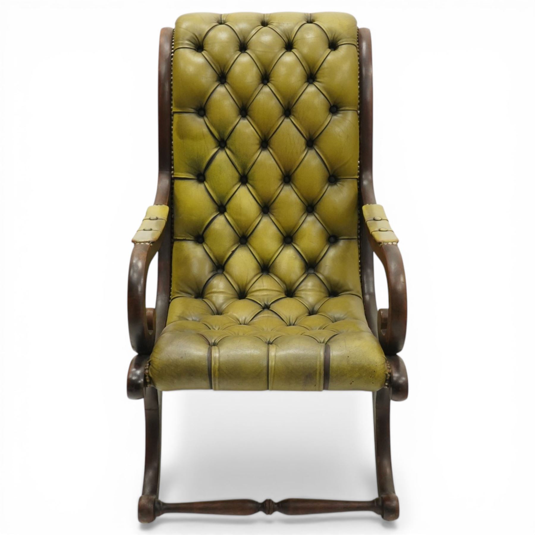 Regency design slipper chair upholstered in buttoned green leather, down swept arms with padded sections, swept back and shaped frames