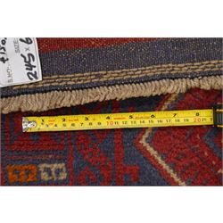 Near pair of Afghan Meshwani runner rugs, each with four red lozenge medallions on a blue ground interspersed with hooked geometric motifs, enclosed by patterned red borders, striped kilim end panels (2)
