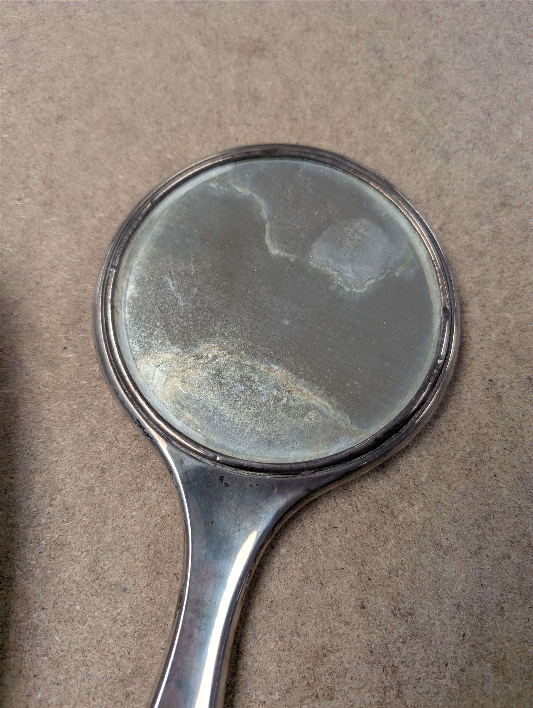 Silver mounted hand mirror and clothes brush, both hallmarked 