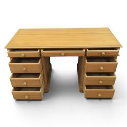 Solid pine twin pedestal desk, fitted with nine drawers, fielded panelled sides