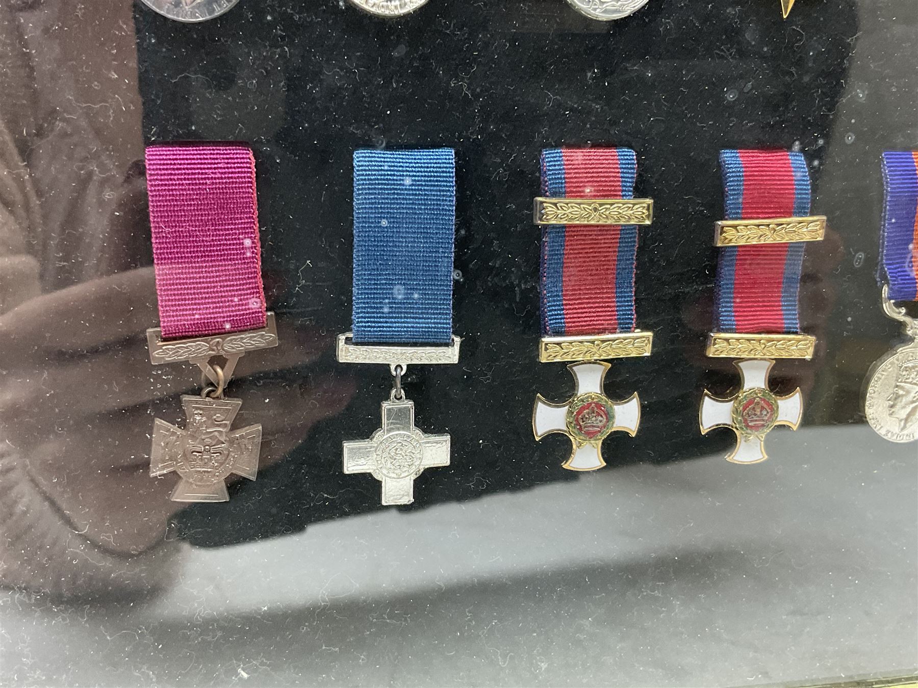 Limited edition large framed display board with sixty half-size copies of British Gallantry and Campaign Medals produced by Danbury Mint; all with ribbons and associated booklet
