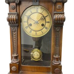 A German HAC wall clock with an eight-day spring driven movement, striking the hours on a gong, with a two-part ivorine dial and pierced gothic hands, gridiron pendulum with beat plate. 

