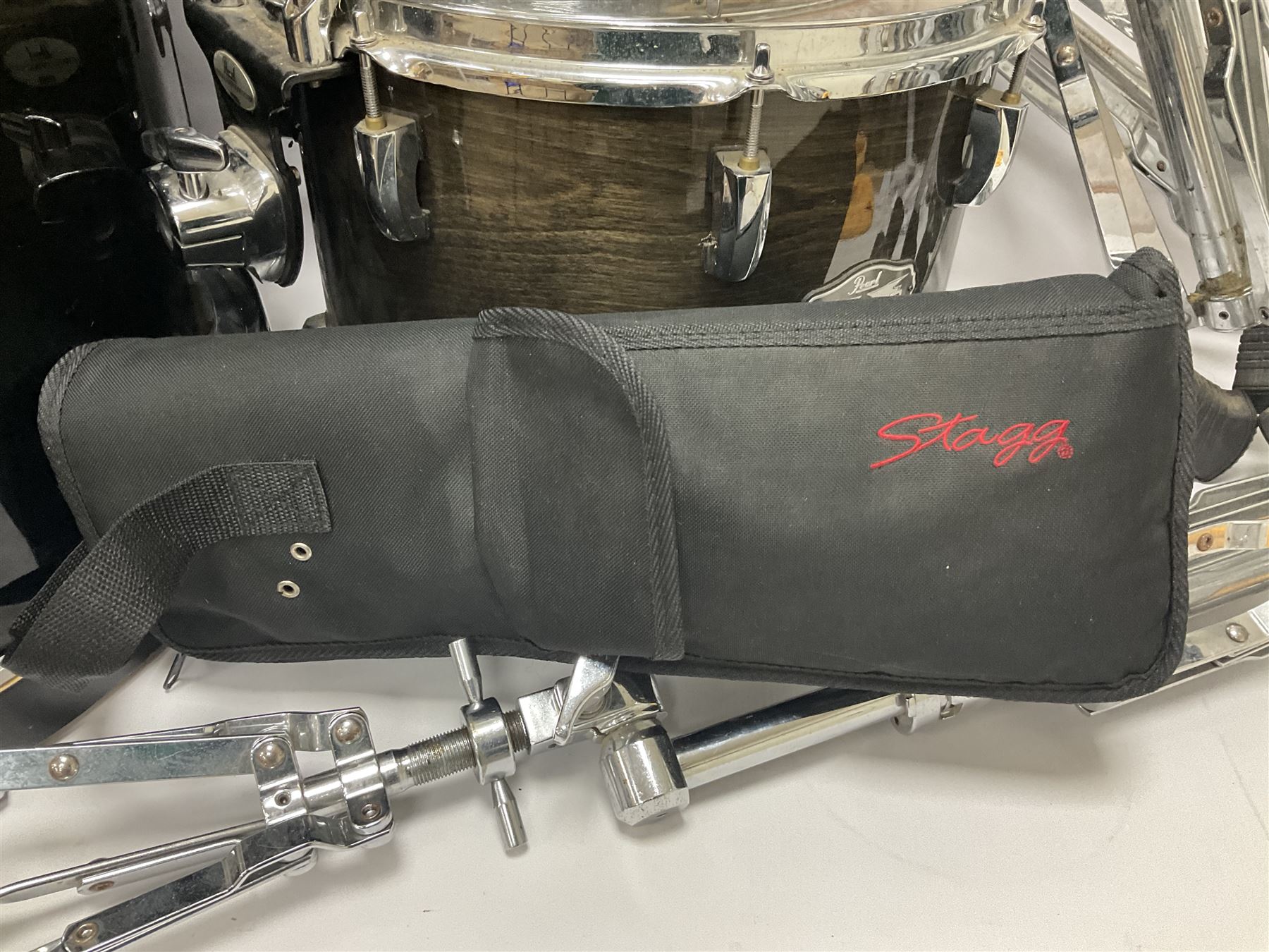 Pearl Vision SST Birch Ply shell four-piece drum kit in black comprising bass drum with foot pedal and three graduated toms; together with Pearl Custom Alloy Sensitone steel snare drum, drum and cymbal stands, microphone stand, stool and various drum sticks 