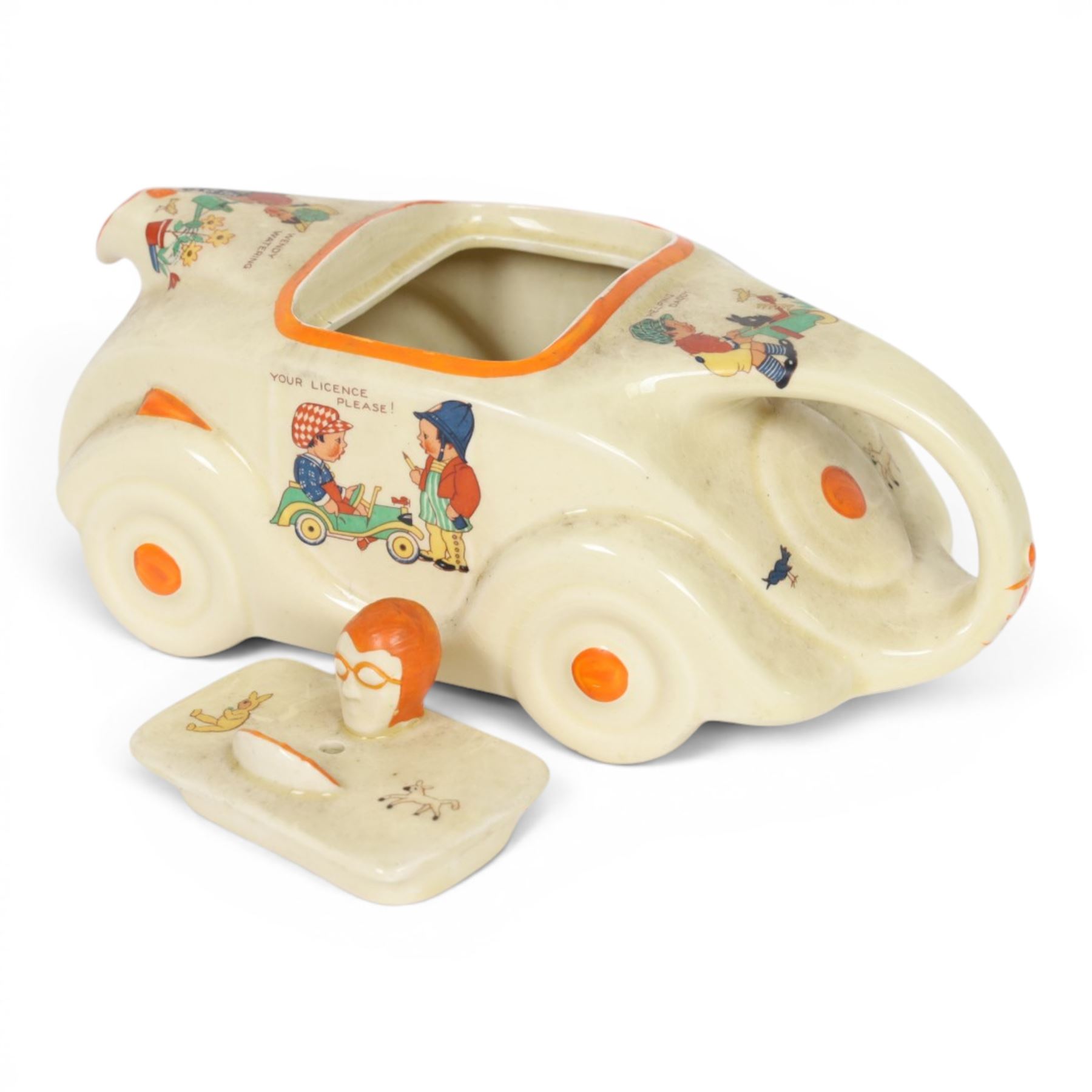 Sadler Art Deco teapot, modelled as a racing car with printed designs in the manner of Mabel Lucie Attwell, H10cm, L23cm