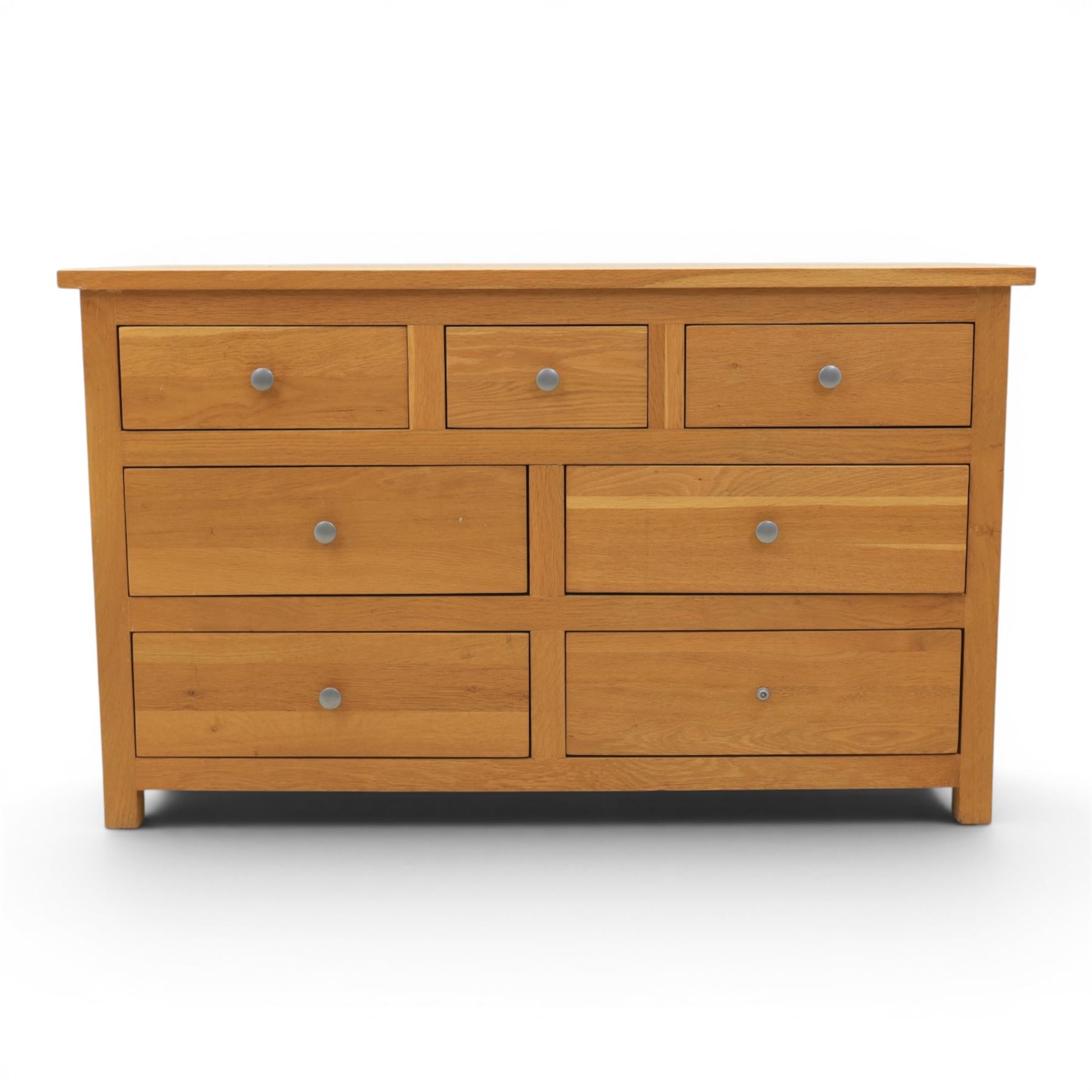 Solid oak chest of drawers, three over four drawers with metal pulls 