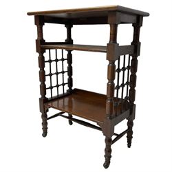 Late 19th century oak three-tier stand or bookcase, on turned supports with lattice sides, on turned feet with castors