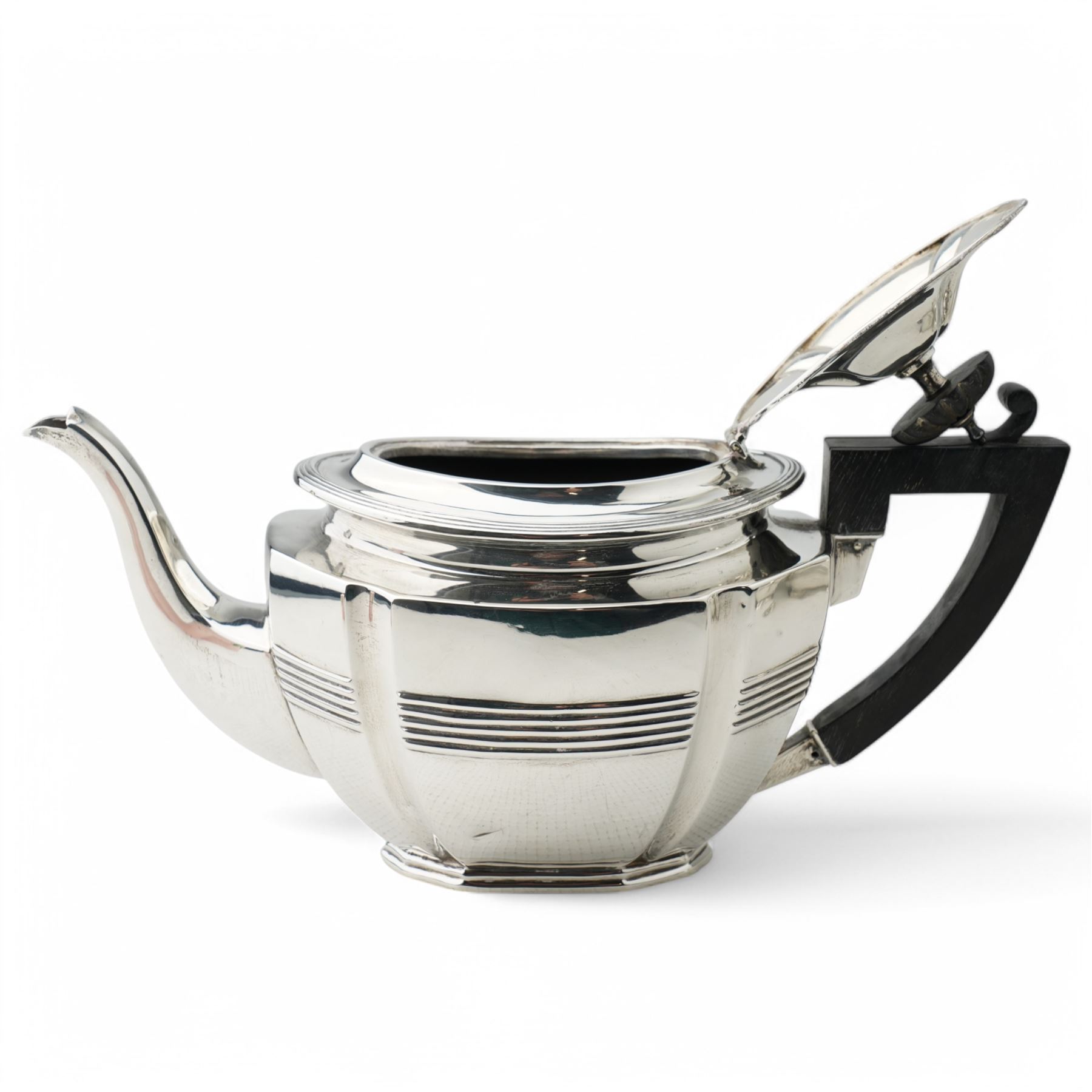 Late Victorian silver three piece tea set of panel sided oval design, the teapot with ebonised handle and lift, Chester 1898/99 Maker Florence Warden and William Aitken