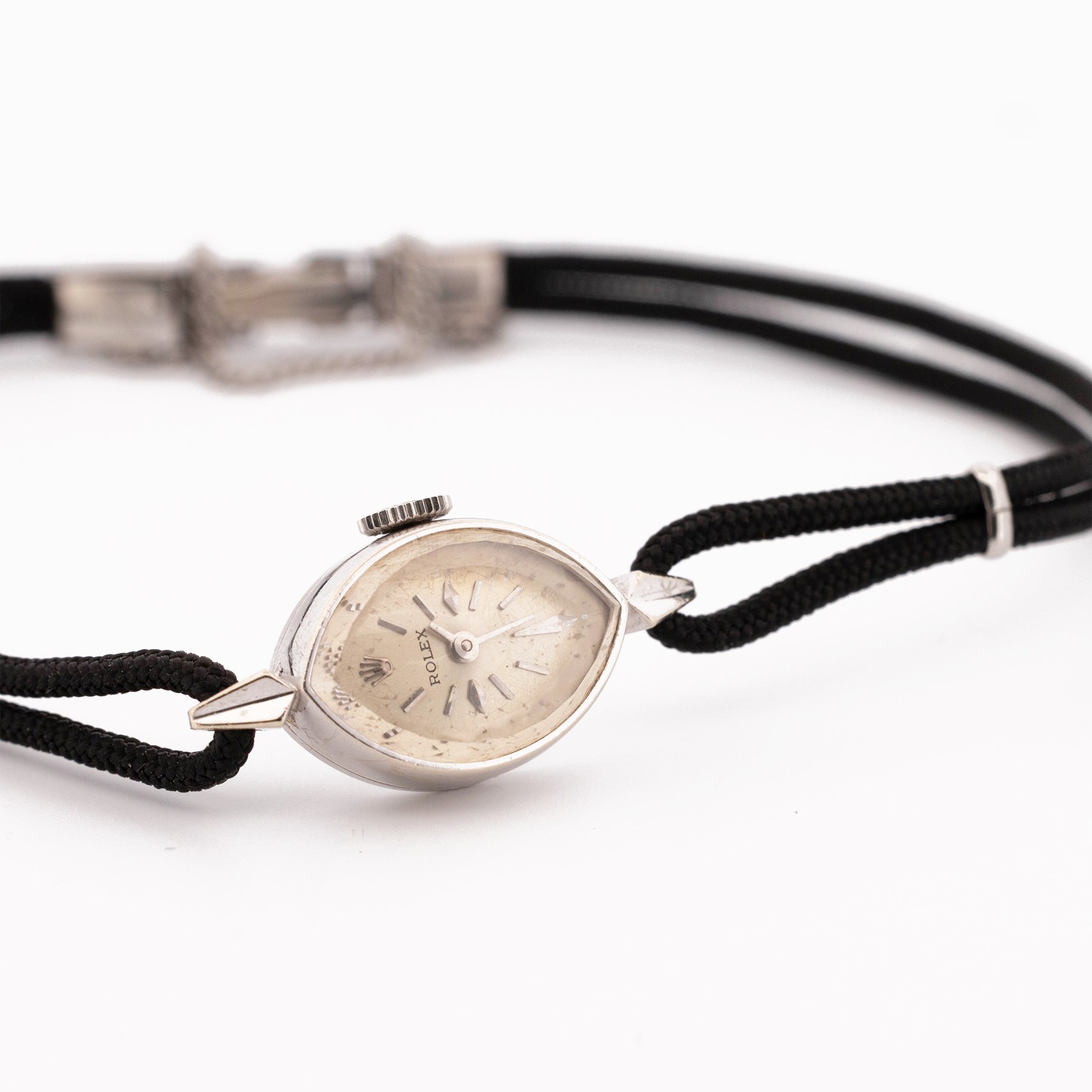 Rolex ladies 14ct white gold manual wind wristwatch, circa. 1960's, silvered dial with baton and diamond hour markers, marquise shaped case, stamped 14K, on black cord bracelet