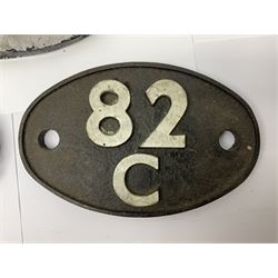 One cast iron and two metal carriage number plates, each of oval form, detailed 85A, 85B and 82C