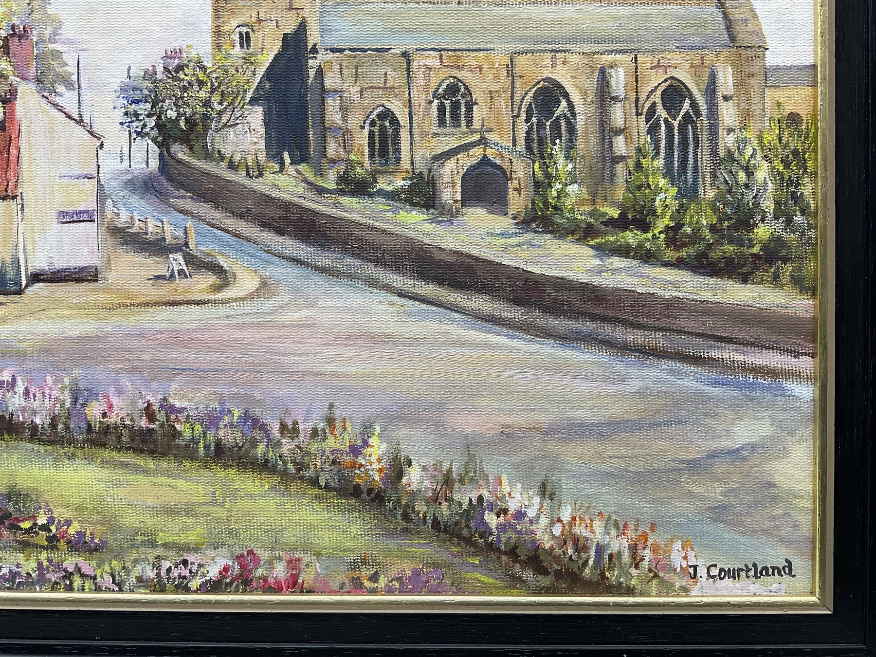 J Courtland (British 20th century): 'Hunmanby Village' near Filey, oil on canvas board signed, titled verso 30cm x 40cm