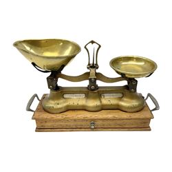 Pair of gilded iron scales mounted on wood twin handled base with drawer and quantity of brass weights