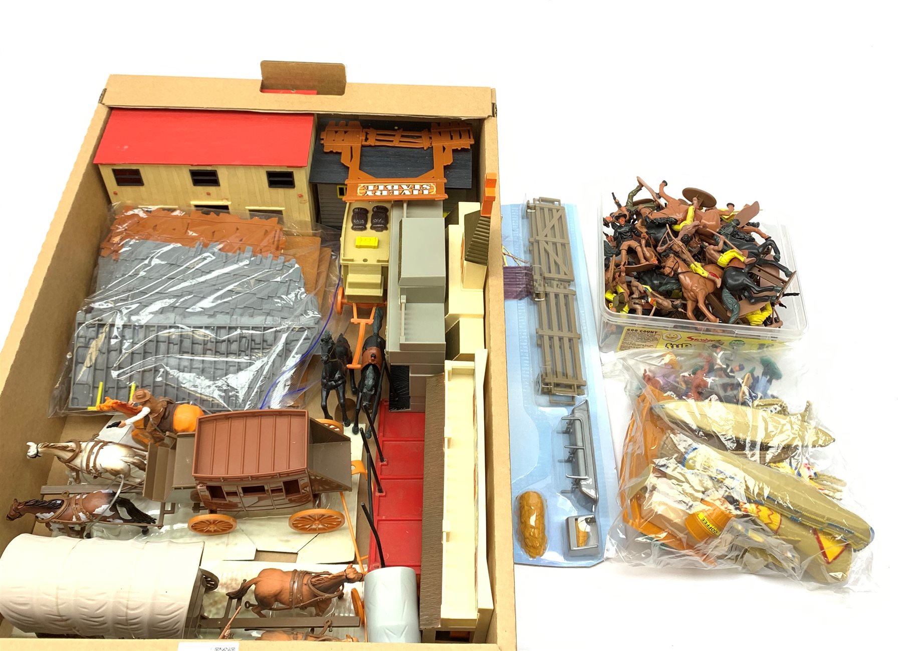 Frontierland play setting with plastic cowboy and Indian figures, totem poles, wig-wams, canoes, various town buildings, covered wagons, stage coaches etc