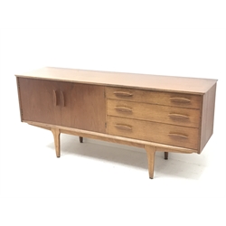 Mid 20th century teak sideboard, three graduating drawers, two cupboard doors, tapering supports, W168cm, H75cm, D45cm

