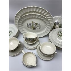 Royal Doulton dinner wares decorated in the Sutherland pattern, comprising two serving platters, one tureen and cover, six twin handled soup bowls and saucers, eight bowls, six dinner plates, seven side plates, and jug. 
