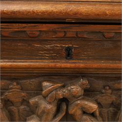Carved oak coffer bench, rectangular moulded top above carved fall front, with figural, mask and foliate decoration, panelled sides, raised on turned bun feet with shaped lower apron