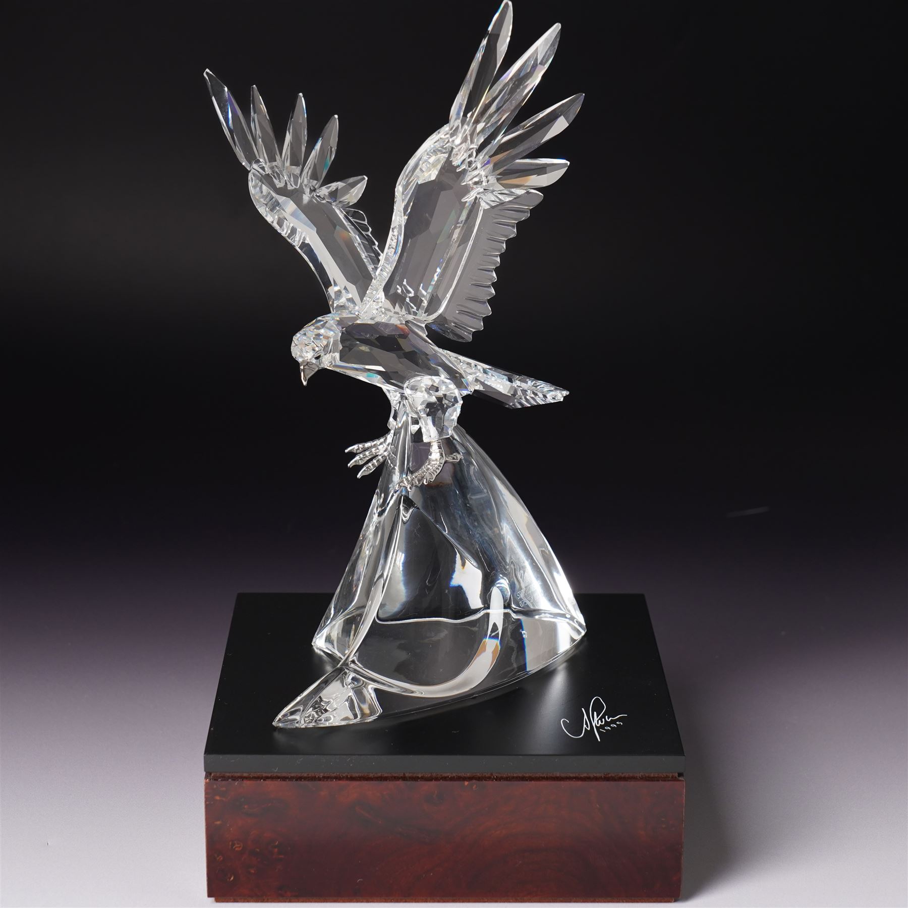 Swarovski, The Eagle, modelled as an eagle in flight upon a wooden base, limited edition 7515/10000, with certificate and case