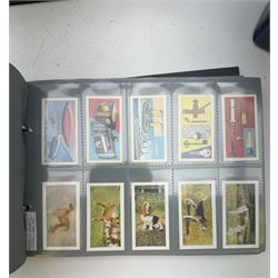 Cigarette, tea and other trade cards, including Ty-phoo, Cavanders Ltd, Rockwell Publishing, Wills, Disney Treasures, various reprint cigarette cards etc, Housed in various ring binder albums and booklets